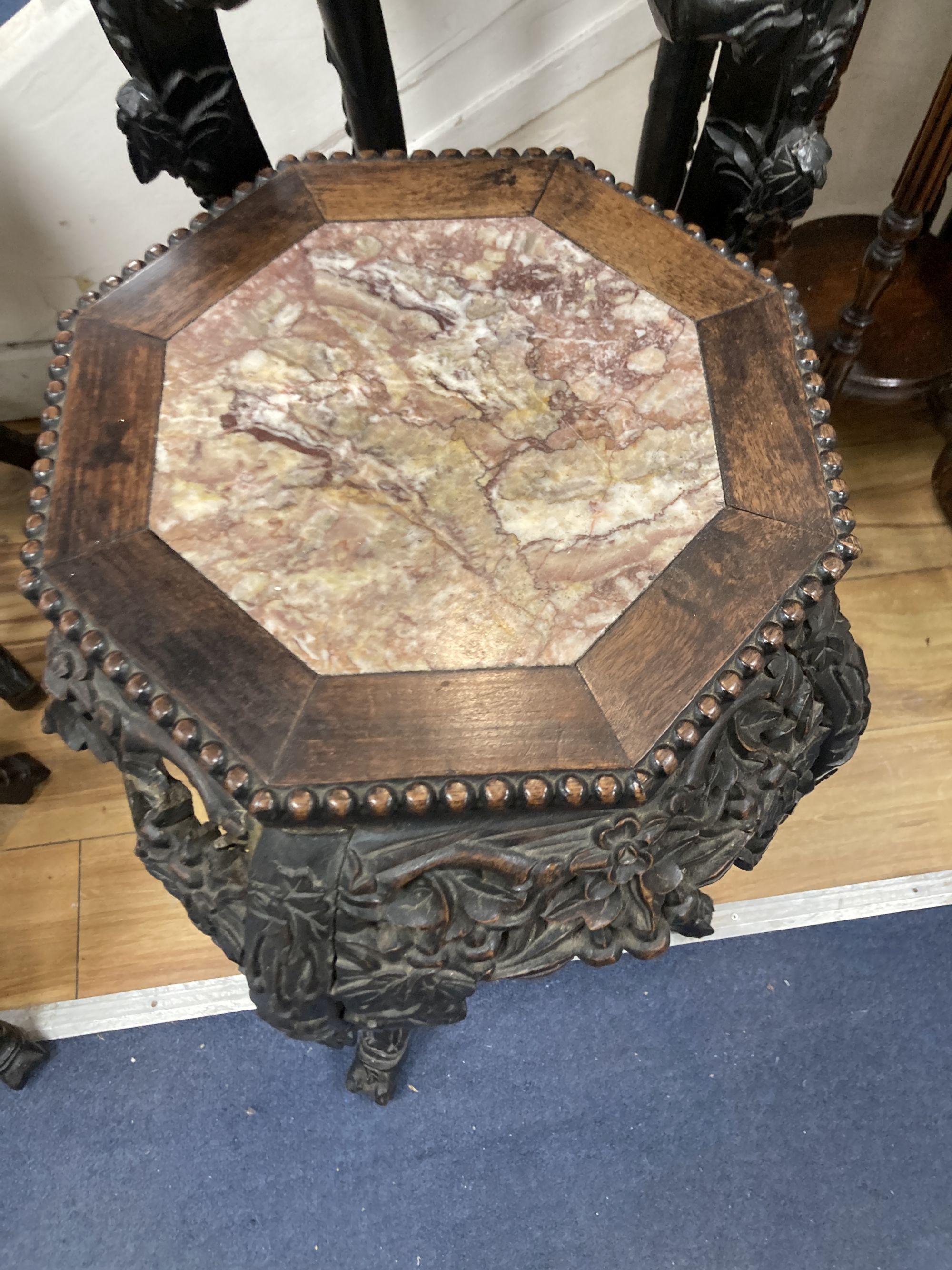 Two Chinese hongmu and marble inset octagonal stands, late 19th century, largest width 40cm height 90cm